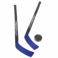 two hockey sticks and an ice puck on a white background, one is black and the other is blue