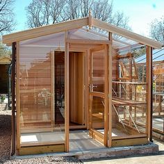 an outdoor sauna with wooden walls and doors