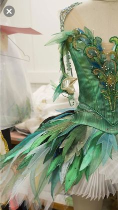 a dress made out of green feathers and beads