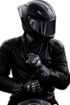 a man in a leather jacket and helmet is sitting on a motorcycle with his hands clasped