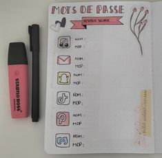 a notebook with notes and pens on it next to a pen that says mots de passe