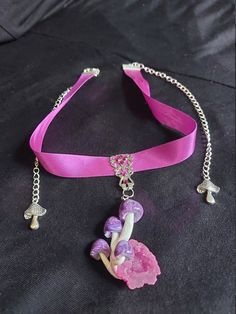 Very pretty little purple swirly mushroom cluster set on a pink quartz geode.  Pendant is set on a filigree piece, adorned with swarovski crystals. Sits on a 13 inch ribbon choker that has extenders on both sides so its able to fit  from 13 to 19 inches, if you need it longer let me know and I can move the clasp. Pink Adjustable Choker For Party, Adjustable Pink Choker For Festivals, Adjustable Pink Choker For Party, Whimsical Purple Jewelry For Gifts, Adjustable Pink Jewelry For Festivals, Adjustable Whimsical Choker, Whimsical Adjustable Choker, Adjustable Whimsical Jewelry For Party, Whimsical Adjustable Jewelry For Festivals