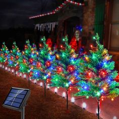 solar powered christmas lights are lined up on the side of a house in front of a row of trees