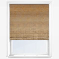 a tan roman blind in a window