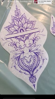 two stickers with designs on them sitting on top of a sheet of plastic foil