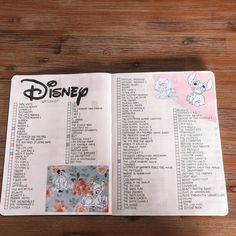 an open disney book sitting on top of a wooden table