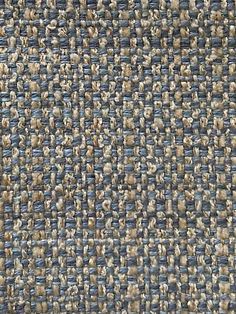 a close up view of a blue and beige tweed fabric textured with small squares