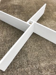 a white object laying on the ground in front of some concrete blocks with one end missing