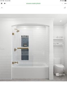 a bathroom with white tiles and gold fixtures on the shower wall, toilet and bathtub