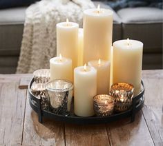 a tray filled with candles on top of a wooden table