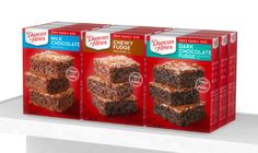 three boxes of brownies with chocolate frosting