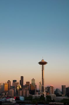 the space needle and seattle skyline at sunset