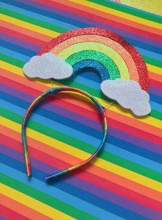 a pair of rainbow hair clips on a multi - colored background