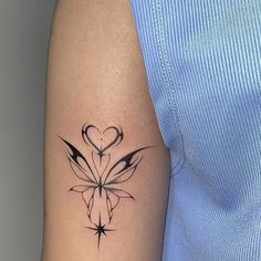 a woman's arm with a heart shaped flower tattoo on the left side of her arm