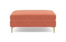 an orange ottoman with wooden legs