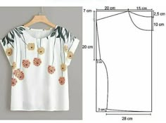 a white blouse with flowers on it and measurements