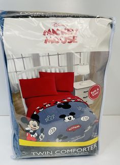 this is an image of a bed in a box with mickey mouse comforter on it