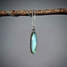 I've set a flashy faceted labradorite gem in sterling silver, with a sweet little hand-sawn botanical peekaboo accent on the back.  It hangs from a stainless steel chain adjustable at 16 inches and at 18 inches.  You will receive the exact necklace shown. Need a longer chain? Just send me a message!  I make all of my pieces myself in my home studio in Michigan. Follow me on Instagram @creationandchaos for updates, promotions, behind the scenes, and my art show schedule! Silver Labradorite Oval Pendant Jewelry, Adjustable Labradorite Necklace Nickel-free, Adjustable Nickel-free Labradorite Necklaces, Adjustable Labradorite Necklace Nickel Free, Adjustable Nickel Free Labradorite Necklaces, Silver Minimalist Jewelry With Large Stone, Minimalist Silver Jewelry With Large Stone, Silver Labradorite Teardrop Necklace, Silver Labradorite Nature-inspired Jewelry