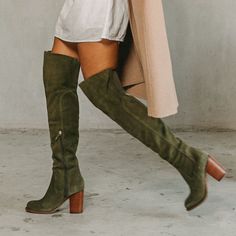 Our best-selling thigh-high boot will elevate any ensemble. The Logan olive over-the-knee boot features a soft, unlined suede upper, an easy to wear heel height, and an elastic back panel at the calf for added comfort. Suede upper in olive Insole: Canvas Lining material: Vamp, canvas and shaft unlined Outsole: Recycled rubber Style type: Over the knee boot Heel material: Stacked Heel height: 3.15 inches Shaft height: 20 inches Calf circumference: 14 inches Brass functional inside zipper Elastic Green Suede Boots Outfit, Knee High Slouchy Boots Outfit, Knee High Suede Boots, Tall Fall Boots, Boots For Winter, Fall Suede Knee-high Boots, Fall Boots Tall, Slouchy Boots Outfit, Green Boots Outfit