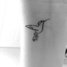 a small hummingbird tattoo on the ankle