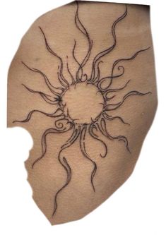 a sun tattoo on the back of a woman's stomach