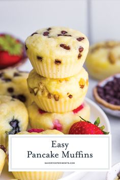 easy pancake muffins stacked on top of each other with strawberries and blueberries in the background