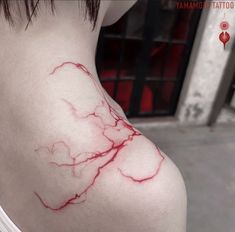 a close up of a person's shoulder with red ink on the back of it