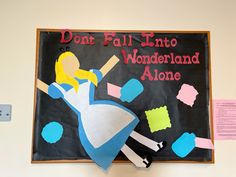 a sign that says don't fall into wonderland alone on the side of a wall