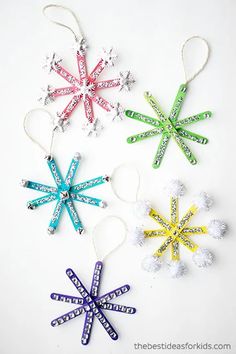 three snowflakes are hanging from string