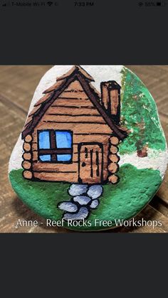 a rock with a house painted on it