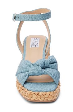 A knotted vamp accent brings modern dimension to a boho-cool sandal lifted by a raffia-wrapped platform and integrated wedge heel. 3" heel; 1" platform Adjustable ankle strap with buckle closure Cushioned footbed with arch support Synthetic upper, lining and sole Imported Chic Blue Wedge Sandals For Beach, Casual Summer Wedge Sandals With Wrapped Heel, Casual Straw Espadrilles With Wrapped Heel, Trendy Beach Wedge Sandals With Wrapped Heel, Fabric Platform Sandals For The Beach, Trendy Wedge Sandals With Wrapped Heel For Beach, Chic Fabric Sandals For Vacation, Casual Beach Wedge Sandals With Wrapped Heel, Beach Fabric Espadrilles With Wedge Heel