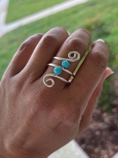 This beautiful Silver Wire Wrapped Ring is very elegant and specially designed to make you look gorgeous and to be a complement of that special outfit.  You can also give it as a anniversary gift or as an statement gift for your special girlfriend. It can also be part of the marvelous girls of your bridesmaids group.  This precious ring is made with a silver tone wire and a turquoise tone glass bead wrapped in a beautiful shape.  The tone of the wire can be changed. I T E M ~D E T A I L S  Mater Wire-wrapped Open Ring For Promise, Wire Wrapped Open Ring For Promise, Sterling Silver Wire Wrapped Toe Ring, Adjustable Wire Wrapped Open Ring, Elegant Wire Wrapped Toe Rings, Adjustable Wire Wrapped Crystal Ring For Wedding, Elegant Silver Wire-wrapped Crystal Ring, Adjustable Wire Wrapped Crystal Wedding Ring, Adjustable Silver Rings Hand Wrapped