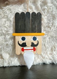 a wooden nutcracker ornament hanging on a wall