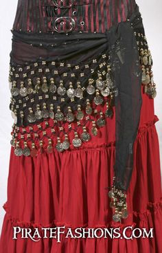 a woman's red and black dress with beads on it