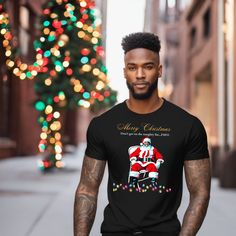 Looking for a funny and unique Christmas gift? Look no further than our folding chair black Santa shirts! These shirts are perfect for anyone who loves black culture and celebrating Christmas. Not only are they great gifts for friends and family, but they're also perfect for dressing up as your favorite black santa claus. Order yours today and enjoy the laughs with everyone you know this holiday season! This classic unisex jersey short sleeve tee fits like a well-loved favorite. Soft cotton and quality print make users fall in love with it over and over again. These t-shirts have-ribbed knit collars to bolster shaping. The shoulders have taping for better fit over time. Dual side seams hold the garment's shape for longer.  .: 100% Airlume combed and ringspun cotton (fiber content may vary Santa Pajamas, Xmas Tees, Black Santa, Santa Shirts, Group Shirts, Unique Christmas Gifts, Black Culture, Folding Chair, Family Shirts