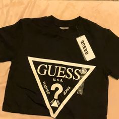 Guess Crop T-Shirt Black Guess Logo Nice New Size Xsmall Bundle Your Items To Save On Shipping! Box-A4 Fitted Logo Top With Short Sleeves, Fitted Short Sleeve Tops With Logo, Logo Fitted Crew Neck Top, Black Fitted Tops With Logo, Casual Short Sleeve Logo Top, Black Logo Top With Short Sleeves, Black Short Sleeve Tops With Logo, Black Graphic Print Cropped T-shirt, Casual Black Graphic Print Cropped T-shirt