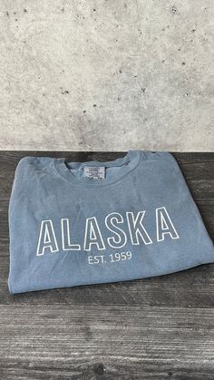 Alaska Embroidered Tee Available in sizes XS - 2X  Comfort Color brand shirt; fits true to size!  If you would like a custom shirt with this lettering, message me! Vintage Cape, Vintage Chanel Handbags, Usa Tee, Comfort Colors Tshirt, Embroidered Gifts, Embroidered Tee, Custom Shirt, Comfort Color, Branded Shirts