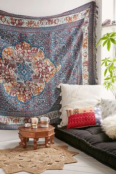 a living room filled with lots of pillows and rugs