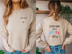 a woman wearing a sweatshirt that says every baby has a story