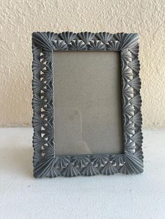 a small gray frame sitting on top of a table