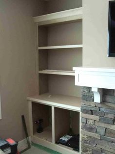 a tv mounted on top of a stone fireplace