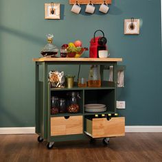 a kitchen with green walls and wooden flooring on the side, has an open shelf that holds various items