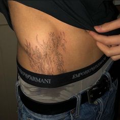 a woman's stomach with tattoos on it and the word emporant written in black