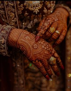 the hands of a bride with henna on