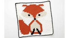 a crocheted square with an image of a red fox on it's face