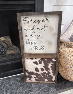 a sign that says forever and not a day less will be written on it in front of a fireplace