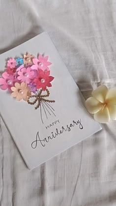 an anniversary card with flowers on it