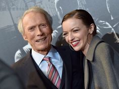 an older man and young woman smiling at the camera