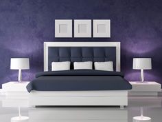 a bedroom with purple walls, white furniture and two lamps on either side of the bed