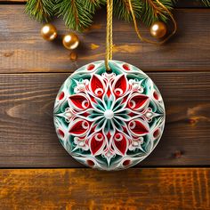 an ornament hanging from a christmas tree on top of a wooden table with ornaments